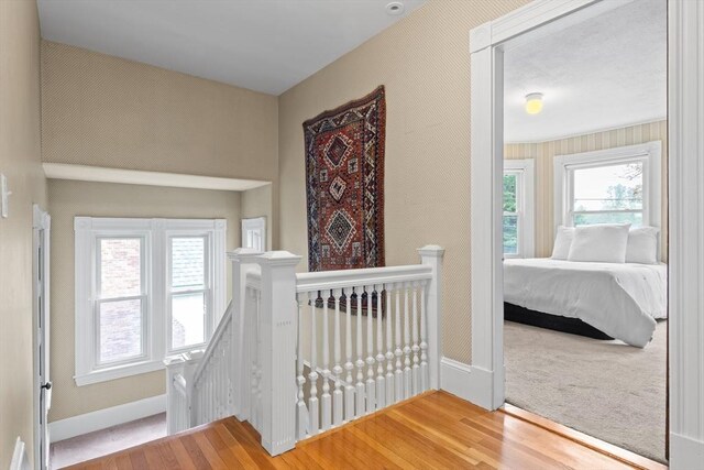 41 Clarke St, Lexington, MA 02421 - corridor with an upstairs landing, baseboards, and wood finished floors