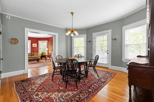 41 Clarke St, Lexington, MA 02421 - dining space with light wood-style floors, crown molding, baseboards, and a chandelier