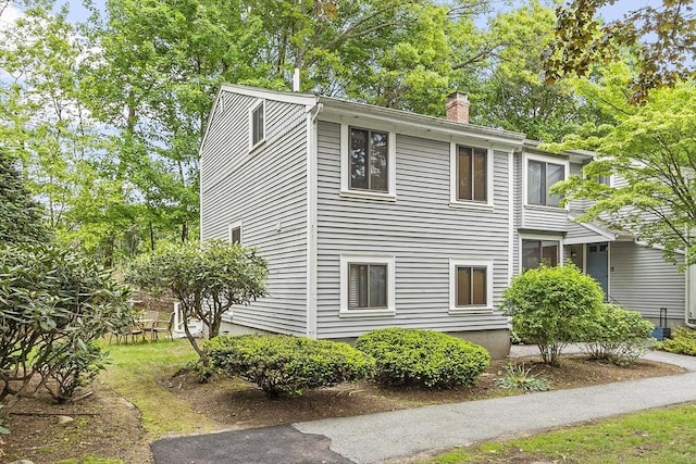 34 Staffordshire Ln Unit 34, Concord, MA 01742 - view of home's exterior featuring a chimney