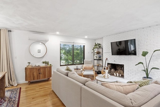 34 Staffordshire Ln Unit 34, Concord, MA 01742 - living room featuring a wall unit AC, a fireplace, light wood finished floors, recessed lighting, and baseboards