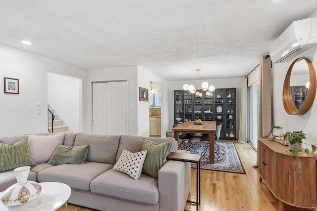 34 Staffordshire Ln Unit 34, Concord, MA 01742 - living room featuring an AC wall unit, a chandelier, light wood-type flooring, stairs, and recessed lighting