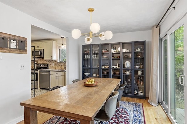34 Staffordshire Ln Unit 34, Concord, MA 01742 - dining area with light wood-style floors, plenty of natural light, and a chandelier