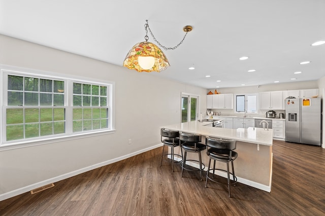 78 Holden Rd, Paxton, MA 01612 - kitchen with stainless steel appliances, baseboards, a breakfast bar, dark wood finished floors, and a sink