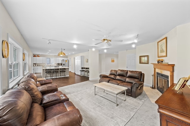 78 Holden Rd, Paxton, MA 01612 - living area featuring a fireplace with flush hearth, ceiling fan, track lighting, and baseboards