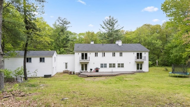 78 Holden Rd, Paxton, MA 01612 - rear view of house with a trampoline, a chimney, a deck, a balcony, and a yard