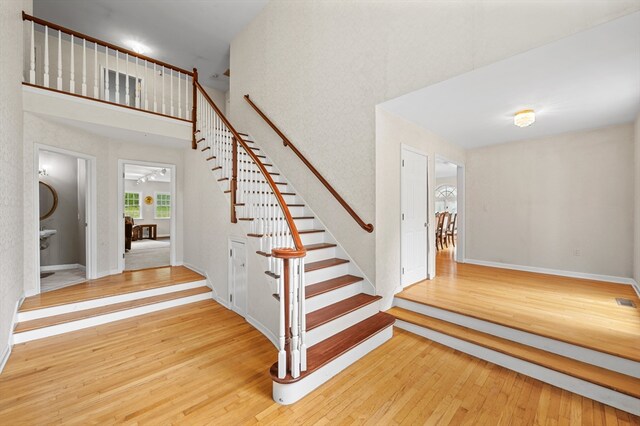 78 Holden Rd, Paxton, MA 01612 - staircase with hardwood / wood-style floors, a towering ceiling, and baseboards