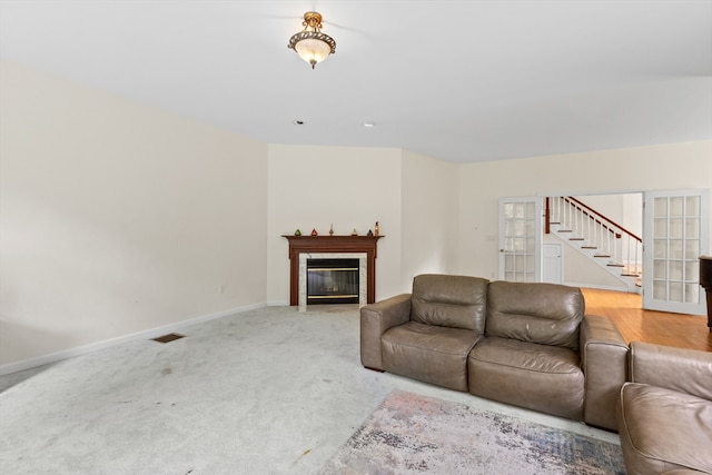 78 Holden Rd, Paxton, MA 01612 - living area with stairs, a glass covered fireplace, baseboards, and light carpet