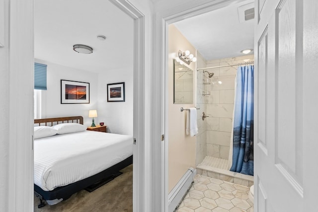 bedroom with light tile patterned floors, connected bathroom, and a baseboard radiator