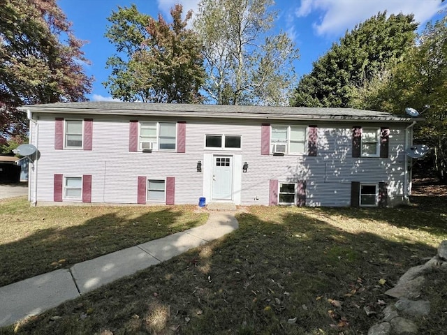 split foyer home featuring cooling unit and a front yard