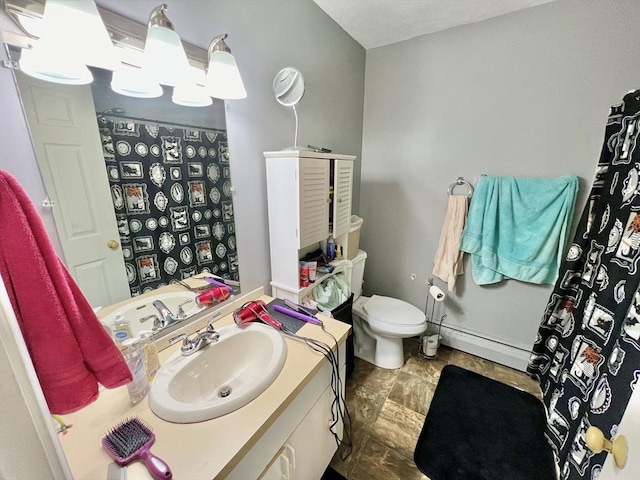 bathroom with vanity, a baseboard radiator, and toilet