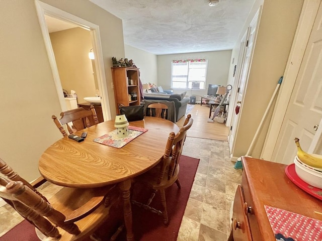 dining room featuring a textured ceiling