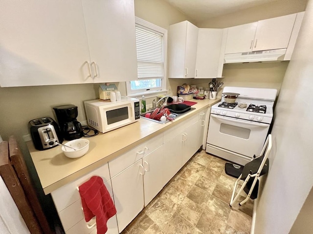 kitchen with white cabinets, white appliances, and sink