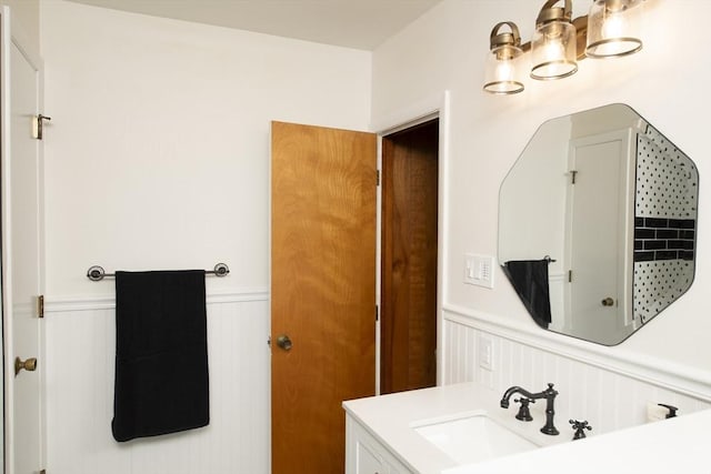 bathroom with wainscoting and vanity