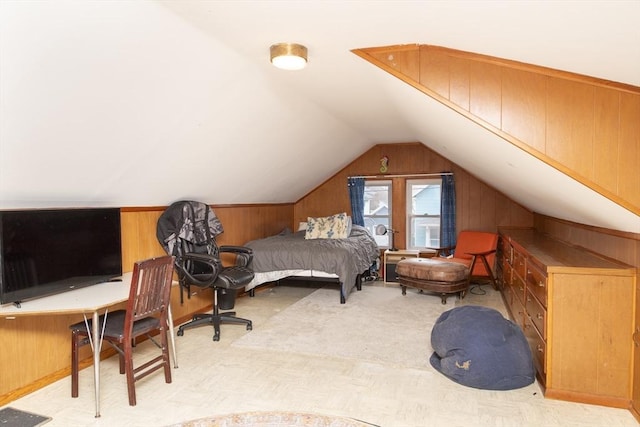 carpeted bedroom with vaulted ceiling and wooden walls