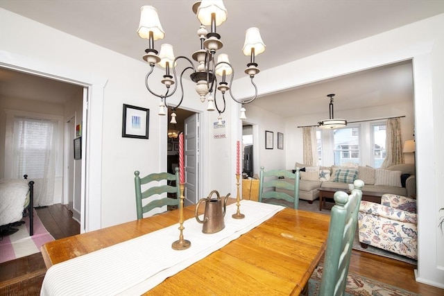 dining room with a chandelier and wood finished floors