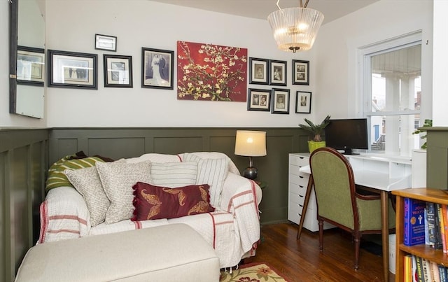 home office featuring a wainscoted wall, a decorative wall, and wood finished floors