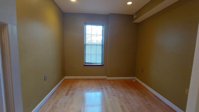 unfurnished room featuring light hardwood / wood-style flooring