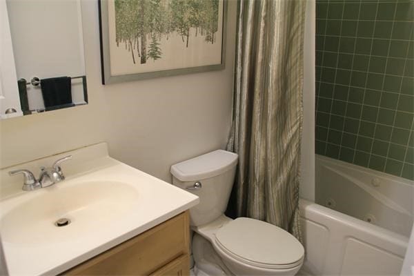 full bathroom with vanity, toilet, and shower / bath combo with shower curtain