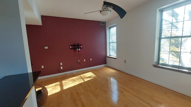 unfurnished room with ceiling fan and light hardwood / wood-style flooring