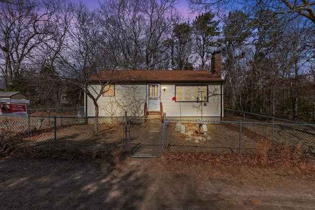 view of front of home featuring a gate, a fenced front yard, a chimney, and entry steps