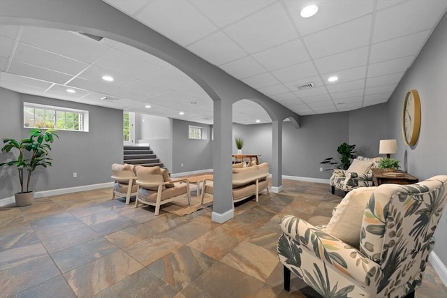 19 Cardiff Rd, Windham, NH 03087 - living area with a paneled ceiling, arched walkways, stone tile floors, recessed lighting, and baseboards