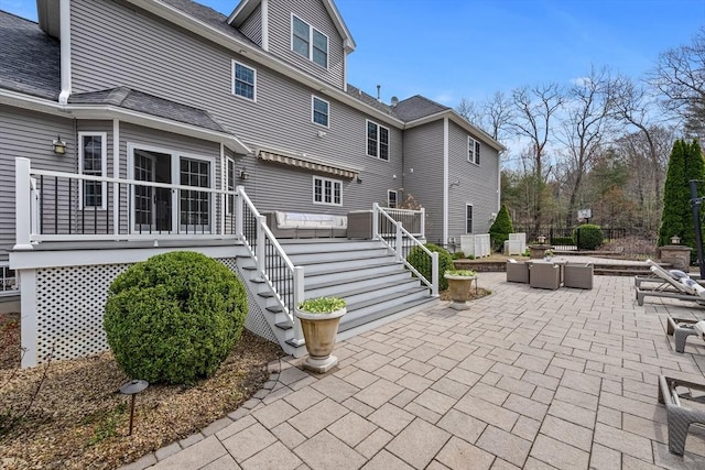 19 Cardiff Rd, Windham, NH 03087 - back of house featuring outdoor lounge area, stairway, a patio area, a deck, and roof with shingles