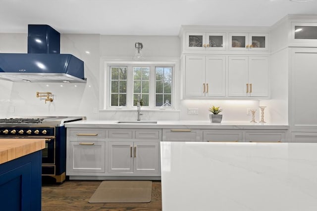 19 Cardiff Rd, Windham, NH 03087 - kitchen with range hood, stove, a sink, white cabinets, and glass insert cabinets