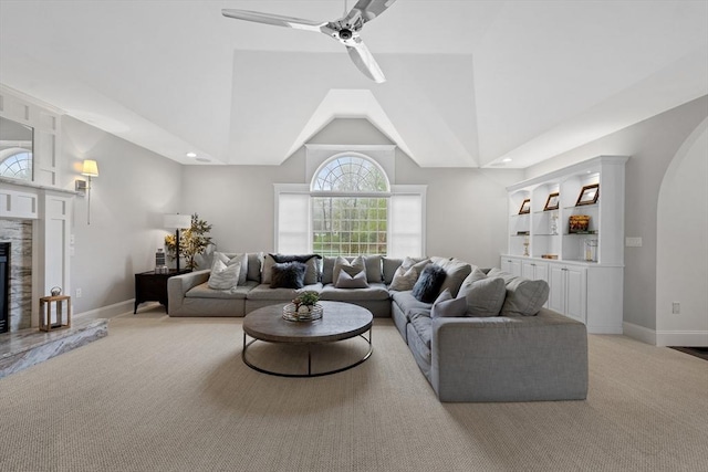 19 Cardiff Rd, Windham, NH 03087 - living room with light carpet, a glass covered fireplace, a ceiling fan, baseboards, and high vaulted ceiling