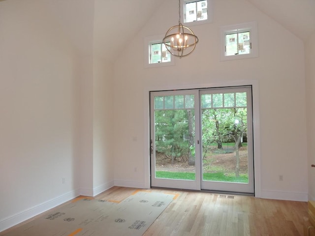 163 Johnson Woods Dr Unit 163, Reading, MA 01867 - unfurnished dining area featuring high vaulted ceiling, a chandelier, healthy amount of natural light, light wood-type flooring, and baseboards