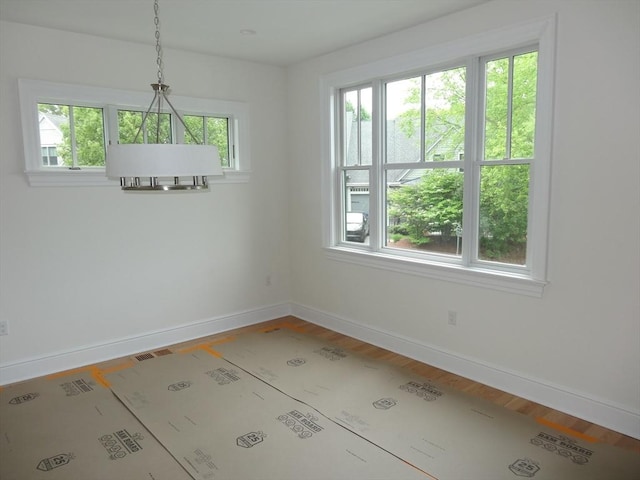 163 Johnson Woods Dr Unit 163, Reading, MA 01867 - unfurnished dining area featuring baseboards and wood finished floors