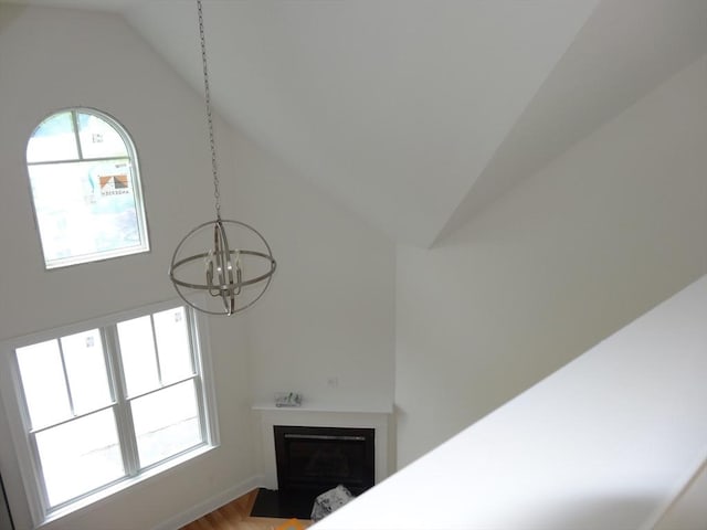 163 Johnson Woods Dr Unit 163, Reading, MA 01867 - detailed view of a chandelier, a fireplace with flush hearth, and wood finished floors