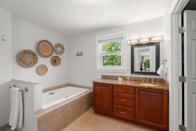 full bath featuring a bath, vanity, and tile patterned floors