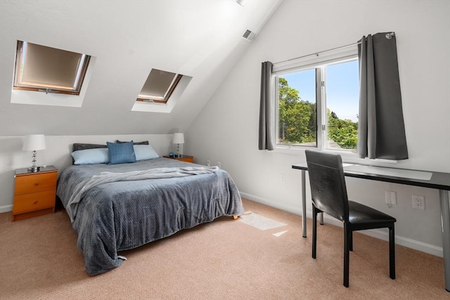 carpeted bedroom featuring vaulted ceiling, a skylight, and baseboards