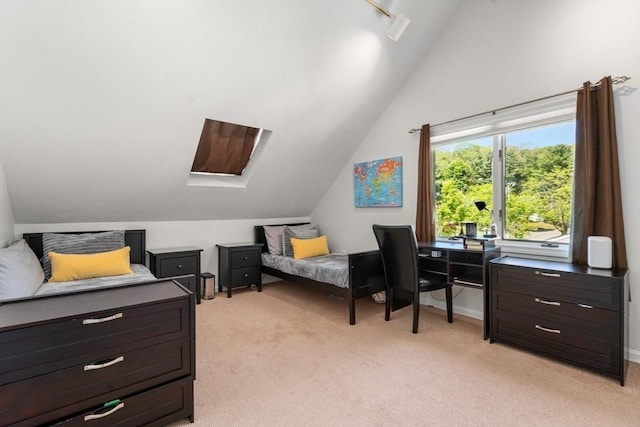 bedroom featuring lofted ceiling and light carpet