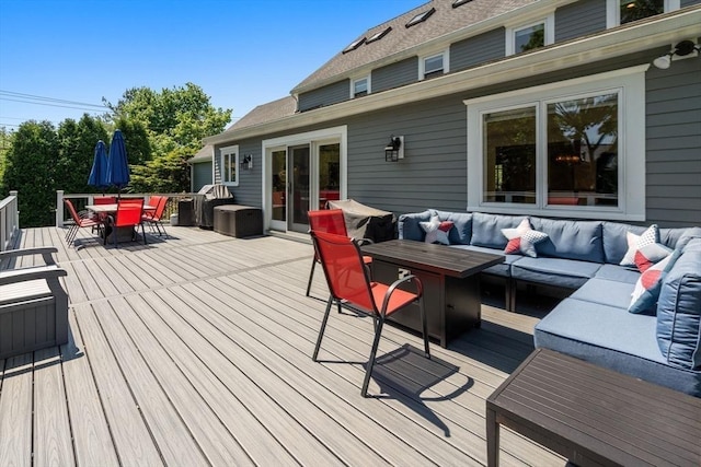 deck with an outdoor living space and outdoor dining space
