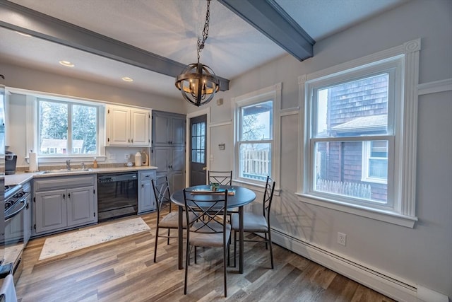 kitchen with beam ceiling, hanging light fixtures, baseboard heating, a notable chandelier, and black appliances