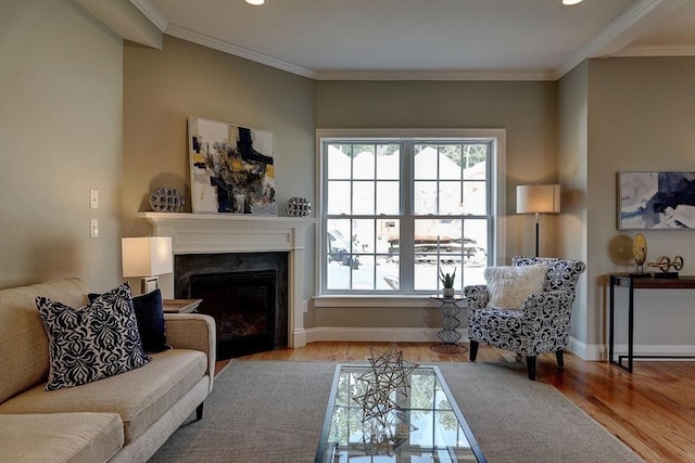 living room with ornamental molding and light hardwood / wood-style flooring