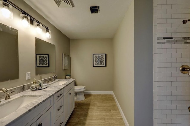 bathroom with hardwood / wood-style flooring, vanity, and toilet