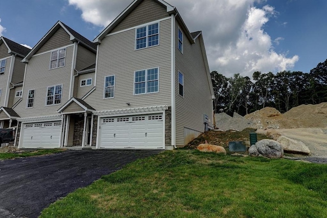 view of front of property with a garage and a front yard