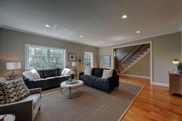 living room featuring ornamental molding and light hardwood / wood-style floors