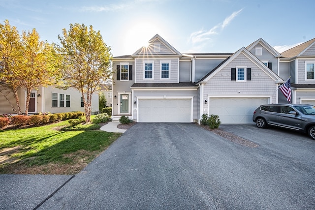 view of property with a front yard and a garage