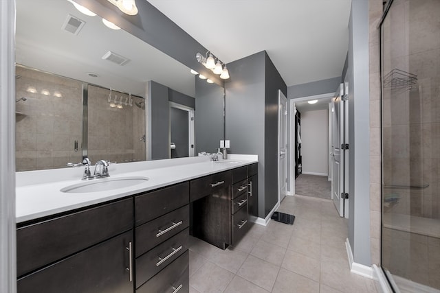 bathroom featuring vanity, tile patterned flooring, and walk in shower