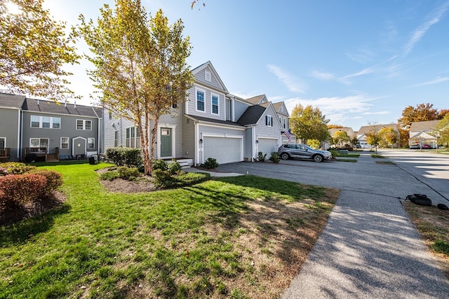 view of front of property with a front yard and a garage