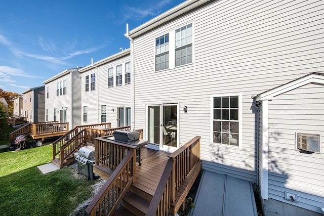 rear view of property with a yard and a deck