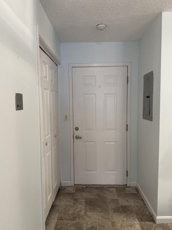 entryway with electric panel and a textured ceiling