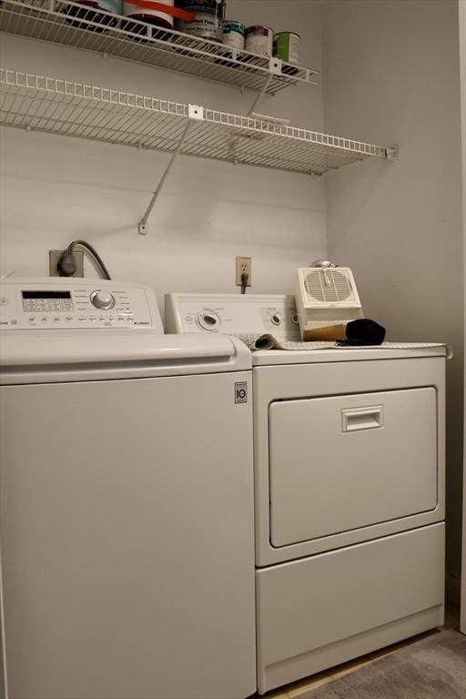 clothes washing area featuring washer and clothes dryer