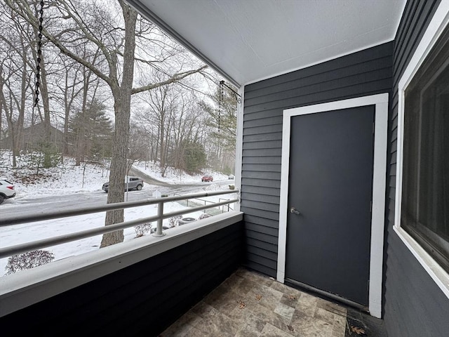 view of snow covered back of property