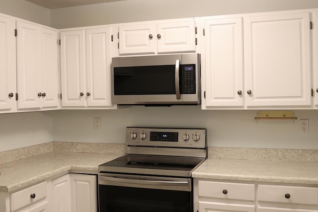 kitchen featuring white cabinets and appliances with stainless steel finishes