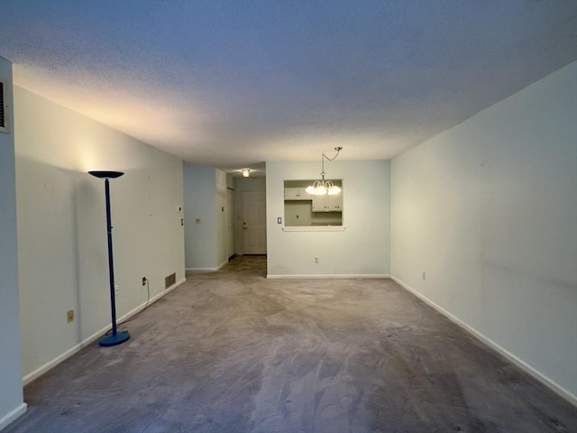 unfurnished room with dark carpet