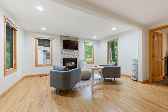 living room with a fireplace and light hardwood / wood-style floors